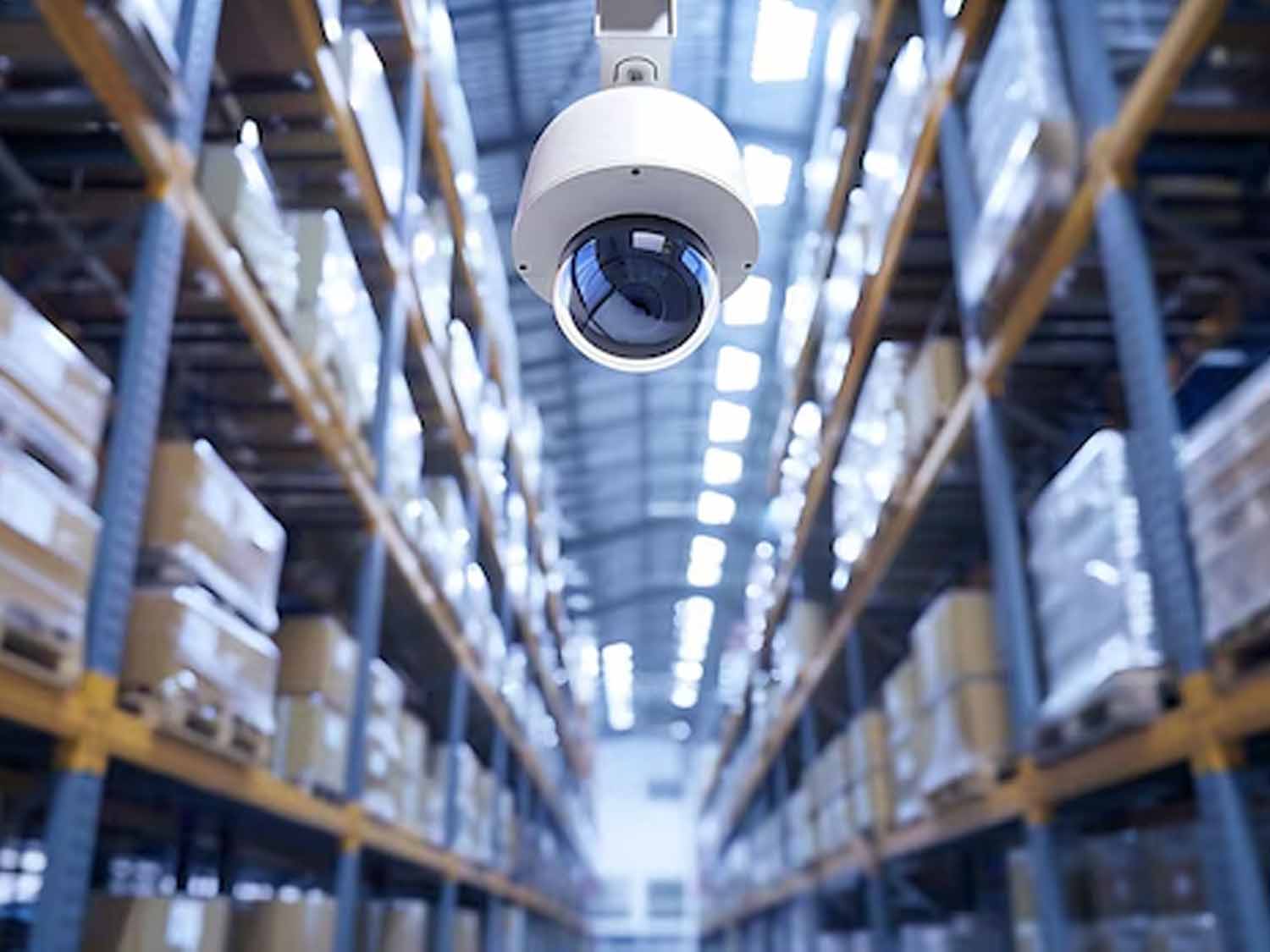 Warehouse security camera installed high on a wall