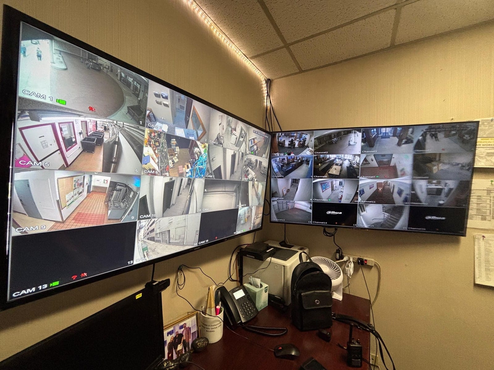 Two monitors at the operator position showing live camera views across the apartment property