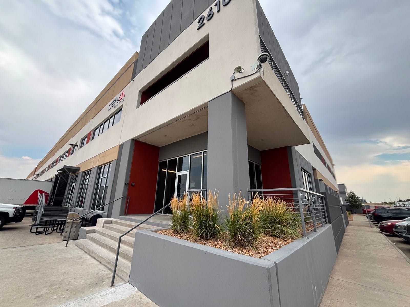 CEVA Logistics building exterior in Denver with a corner camera and horn speaker above the entrance