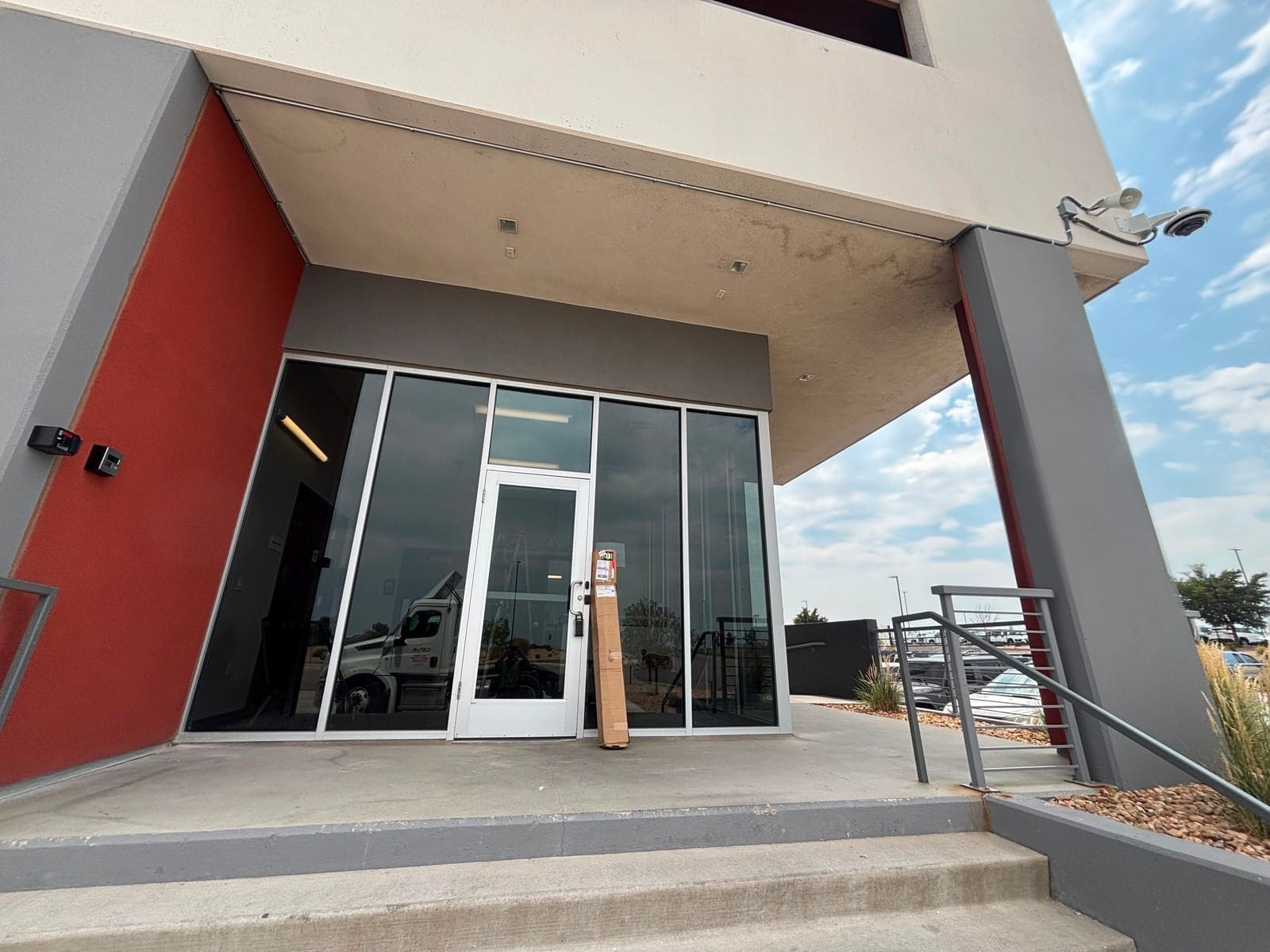 Staff entrance at CEVA Logistics with an access reader at the door frame and a camera above