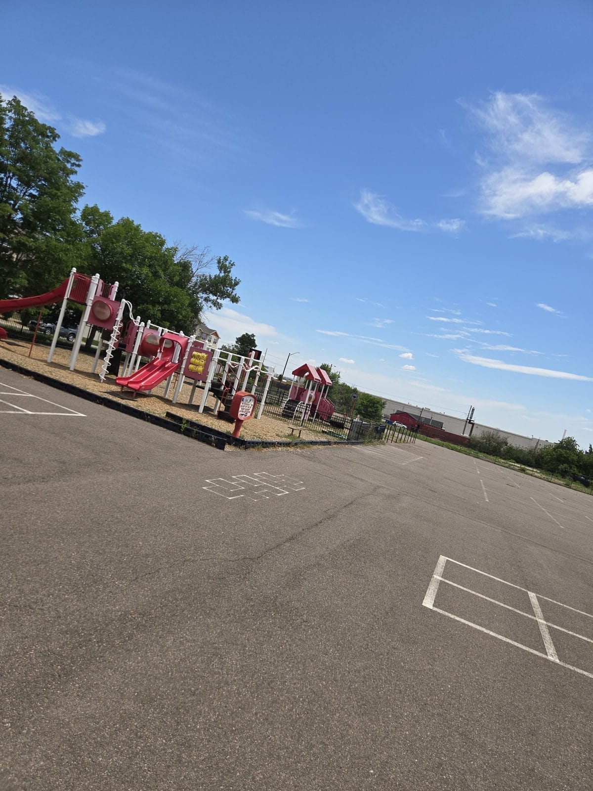 Playground beside a fenced parking area on the Denver Children's Home campus